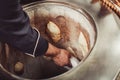 Baker making turkish pita bread in tandoor, clay oven. Baking process. Many fresh hot bread in the basket. Royalty Free Stock Photo