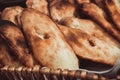 Baker making turkish pita bread in tandoor, clay oven. Baking process. Many fresh hot bread in the basket. Royalty Free Stock Photo