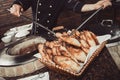 Baker making turkish pita bread in tandoor, clay oven. Baking process. Many fresh hot bread in the basket. Royalty Free Stock Photo