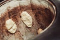 Baker making turkish pita bread in tandoor, clay oven. Baking process. Many fresh hot bread in the basket. Royalty Free Stock Photo