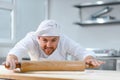 Baker man kneading dough and bakery ingredients. Bakery concept Royalty Free Stock Photo
