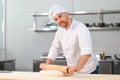 Baker man kneading dough and bakery ingredients. Bakery concept Royalty Free Stock Photo