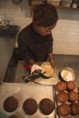 Baker mixing cake batter in a commercial kitchen