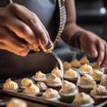 A baker piping icing onto freshly baked cupcakes3