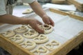 Baker Placing Mirrored Pretzel on Tray Royalty Free Stock Photo