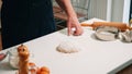 Baker pouring flour on dough for bread Royalty Free Stock Photo