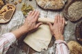 Man rolling out dough on kitchen table, close up Royalty Free Stock Photo