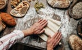 Man rolling out dough on kitchen table, close up Royalty Free Stock Photo