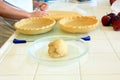Baker preparing dough for an apple pie Royalty Free Stock Photo