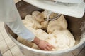 Baker preparing the dough for bread in a dough mixer