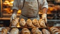 A baker pulls out freshly baked bread from oven, showcasing artisanal baking process. The warm glow of bakery highlights crusty