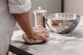 Baker punchs down the dough in the kitchen in the bakery Royalty Free Stock Photo