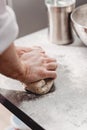 Baker punchs down the dough in the kitchen in the bakery Royalty Free Stock Photo