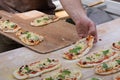 Baker puts small pizzas to slide