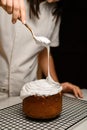 Baker puts white cream on the Easter cake Royalty Free Stock Photo