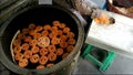 Baker Removing Freshly Baked Khanom Farang Kudeejeen Cakes from the Molds, Thailand