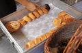 Baker Removing Heap of Freshly Baked Kudeejeen Cupcakes or Khanom Farang Kudeejeen from the Mold