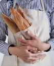 Baker`s hands hold fresh bread