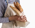 Baker`s hands hold fresh bread