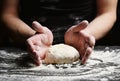 Baker's hands knead the dough