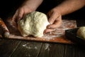 Baker hands knead dough for baking bread. Concept of baking pastry or pies in a bakery