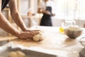 Baker's hands kneading raw dough in bakery Royalty Free Stock Photo