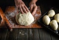 The baker hands are preparing dough for buns on the table close-up. The baker bakes hot dog pies Royalty Free Stock Photo