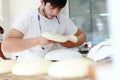 The Baker shapes the dough into a flatbread. Preparation of cakes from yeast dough. The concept of baking or making fresh bread.