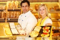 Baker and shopkeeper present pastry Royalty Free Stock Photo