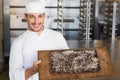 Baker showing freshly baked brownie Royalty Free Stock Photo