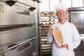 Baker showing freshly baked loaf Royalty Free Stock Photo