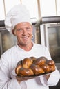 Baker showing freshly baked loaf Royalty Free Stock Photo