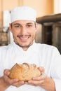 Baker showing freshly baked loaf Royalty Free Stock Photo