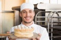 Baker showing freshly baked loaf Royalty Free Stock Photo