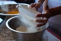Baker sifting flour for bread Royalty Free Stock Photo