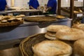 Baker sifting flour through a sieve in bakery shop. Royalty Free Stock Photo