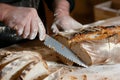 baker slicing bread with a serrated knife Royalty Free Stock Photo