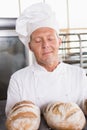 Baker smelling freshly baked breads