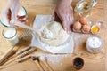 Baker sprinkle the dough with flour bread, pizza or pie recipe ingredients with hands, food on kitchen table background, working w Royalty Free Stock Photo