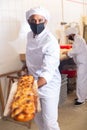 Baker taking baked bread out of oven on wooden shovel Royalty Free Stock Photo