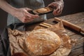 A baker is taking pictures of homemade fresh bread on his phone for a post on social networks. Baking bakery products Royalty Free Stock Photo