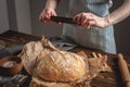 A baker is taking pictures of homemade fresh bread on his phone for a post on social networks. Baking bakery products Royalty Free Stock Photo