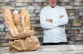 Baker with traditional bread french baguettes Royalty Free Stock Photo