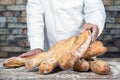 An baker with traditional bread french baguettes Royalty Free Stock Photo