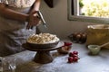 Baker using gas burner on lemon meringue pie