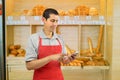 Baker using smartphone Royalty Free Stock Photo