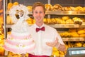 Baker with wedding cake in confectionery