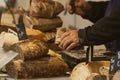 Baker at a weekly market in France, working men's hands