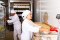 Baker weighs dough on scales in bakery