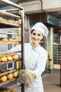 Baker woman pushing sheets with bread in the baking oven Royalty Free Stock Photo